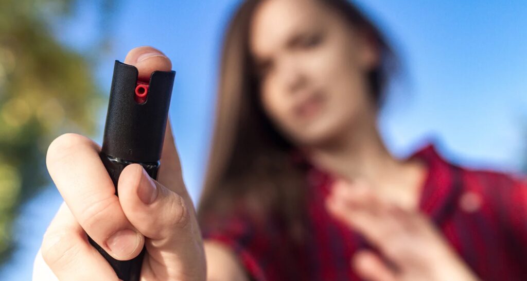 A woman spraying pepper spray