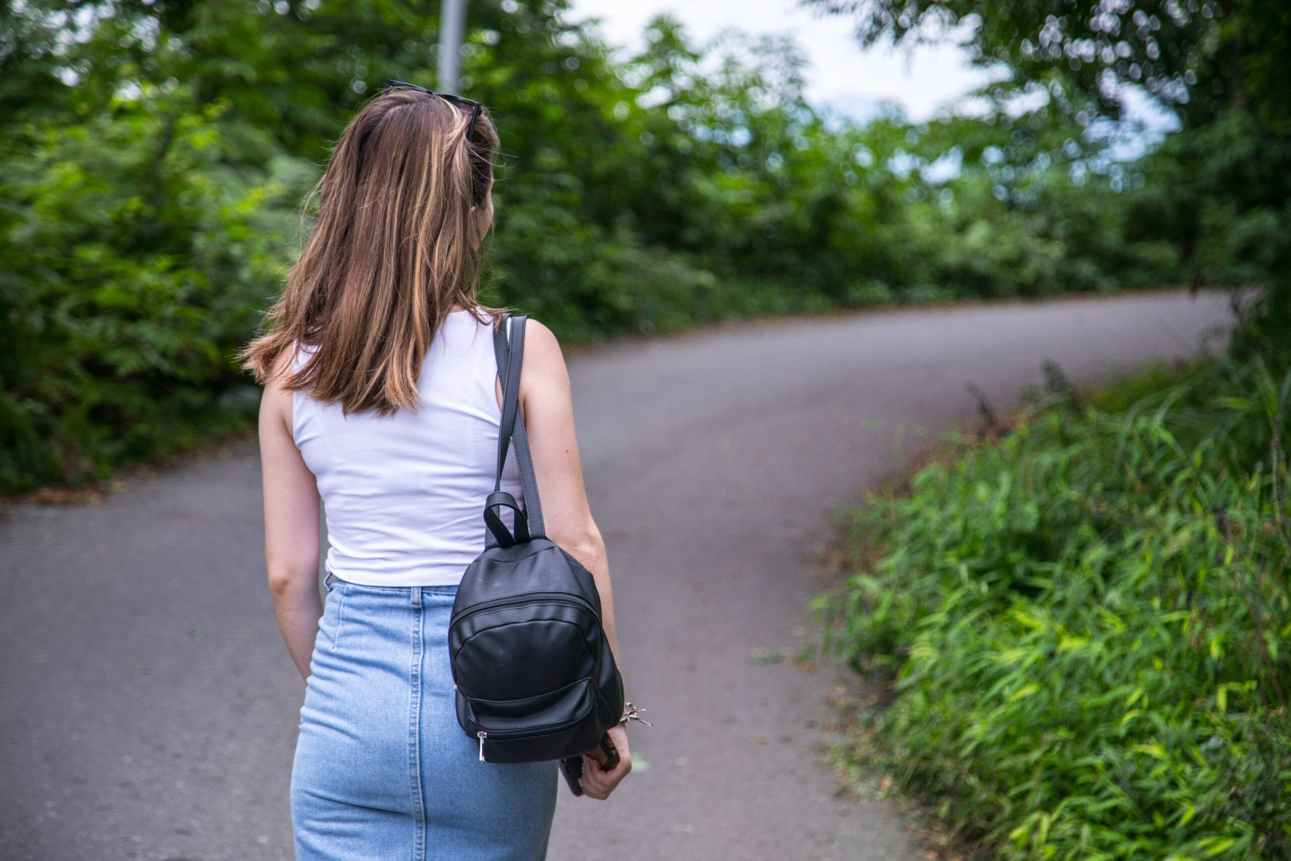 a woman walking alone down a path