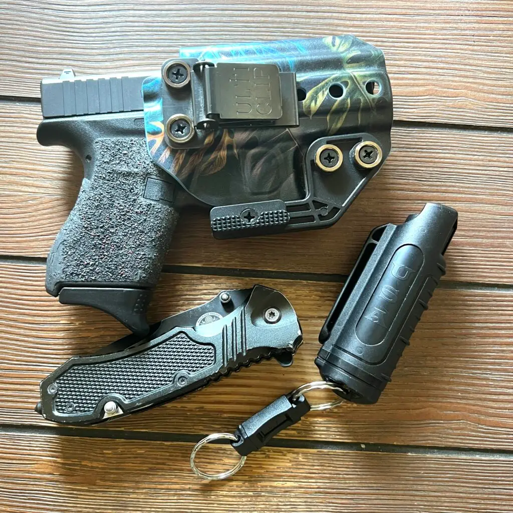 everyday carry essential. gun, knife, mace