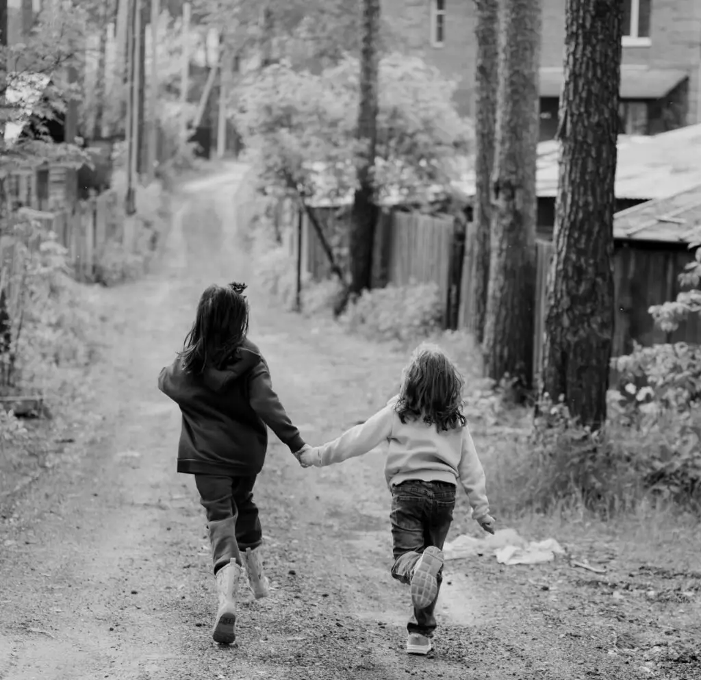 two children walking down a path