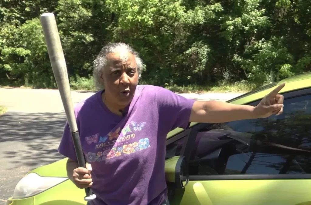 woman holding a baseball bat that she used in self defense