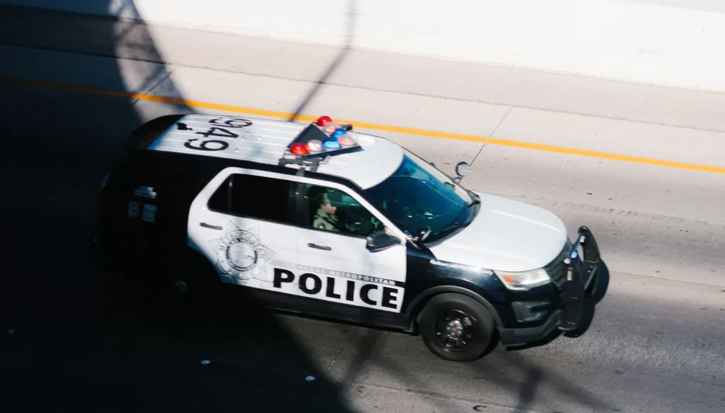 police car driving down the highway