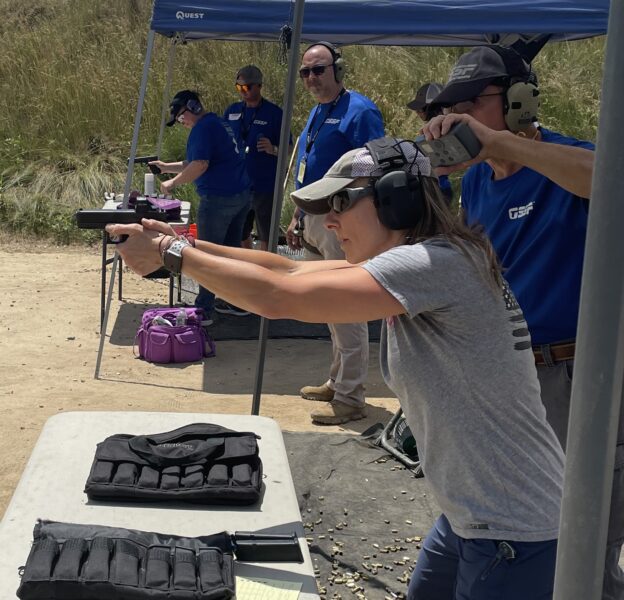 a woman shooting in a shooting competition